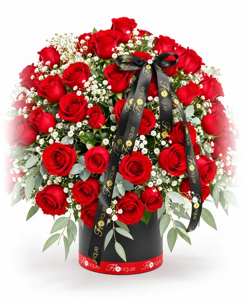 A black hatbox of red roses, baby's breath and eucalyptus, tied with a Florique ribbon