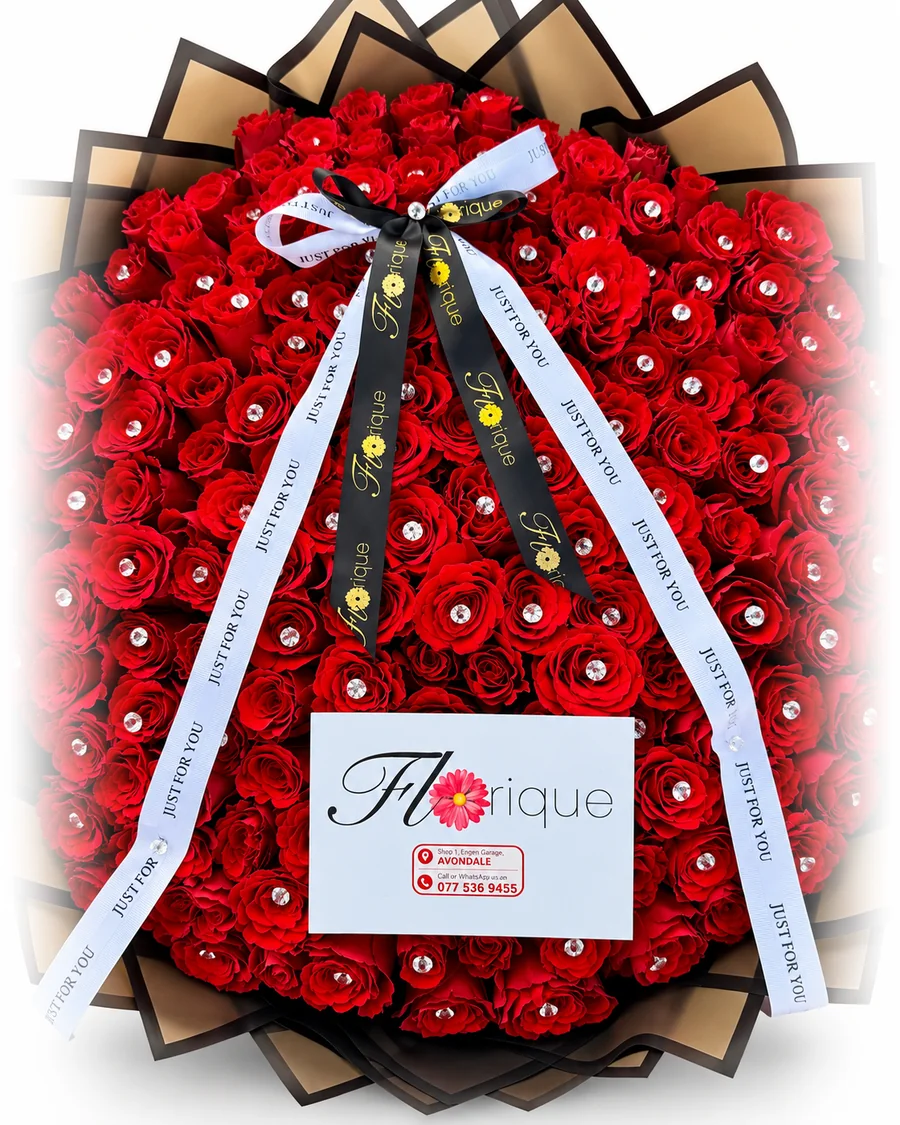 A large round bouquet of red roses with crystal accents, tied with Florique ribbons